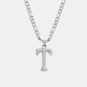 Silver textured initial pendant necklace with a figaro chain.