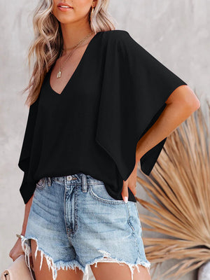 Black V-neck blouse with short, flowy sleeves and a relaxed fit, paired with denim shorts.