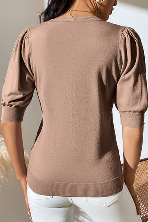 Camel knit sweater with puff sleeves and ribbed cuffs and hem.