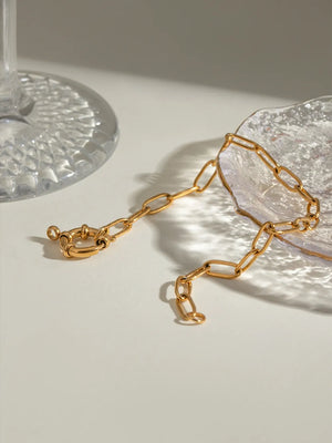 Gold chunky link bracelet with a circular toggle clasp