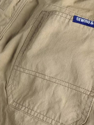 Khaki cargo pants with a back pocket detail and blue brand tag.
