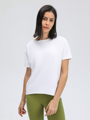 White relaxed fit performance tee with short sleeves and boat neck.