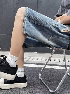 Relaxed fit blue denim shorts with a vintage wash and patch detail.