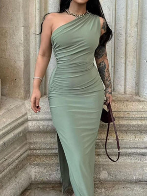 One-shoulder ruched bodycon dress in green with a high slit and draped detailing.