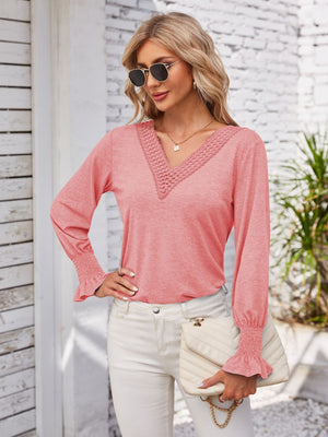 Coral lace trim V-neck blouse with blouson sleeves and smocked cuffs.