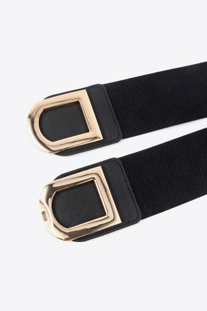 Black elastic belt with double gold D-ring buckles and faux leather trim.