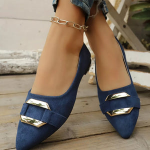 Navy blue slip-on flats with pointed toe and gold buckle detail.