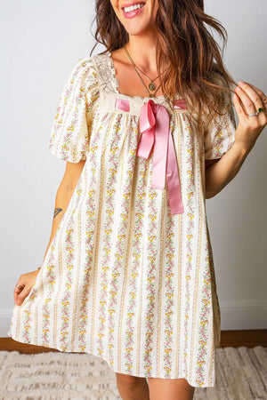 Floral mini dress with lace trim, square neck, short sleeves, and pink bow detail.