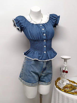 Blue ruffled smocked maternity blouse with puff sleeves, white lace trim and decorative buttons.