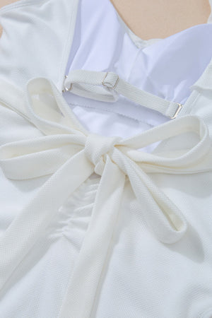 White textured wrap swimsuit with tie back detail and adjustable straps.