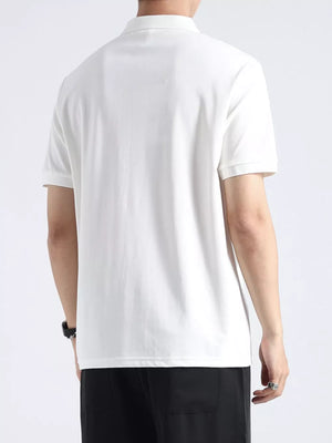 White textured cotton polo shirt with button accents, short sleeves, and a casual fit.