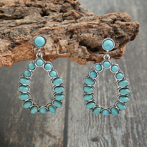 Teal teardrop statement earrings with artificial turquoise stones and alloy metal detail