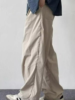 Relaxed fit khaki sweatpants with a drawstring waist and pockets.