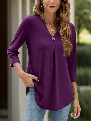 Purple V-neck three-quarter sleeve top with front pleats and a decorative button.
