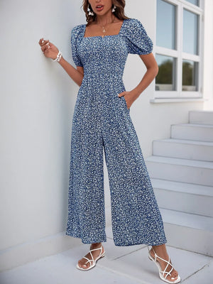 Smocked bodice floral jumpsuit with puff sleeves and wide legs in Royal Blue.