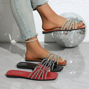 Dazzling rhinestone adorned open-toe slide sandals in black, brown, and red.