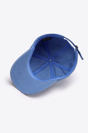 Raw edge denim baseball cap in Cobalt Blue with adjustable strap and visible interior label.