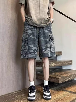 Relaxed fit black camo cargo shorts with multiple pockets and drawstring waist.