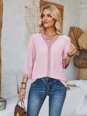 Blush pink eyelet trimmed V-neck blouse with lace detail and 3/4 sleeves.