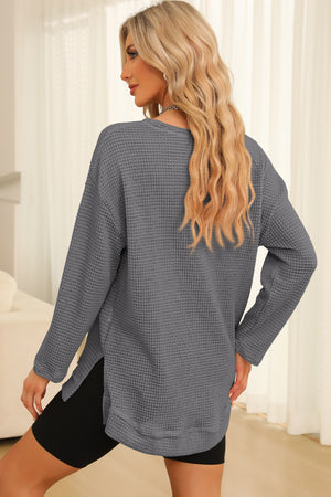 Charcoal waffle knit oversized top with side slits and long sleeves.