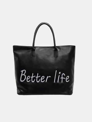 Black tote bag with white "Better Life" graphic and top handles.