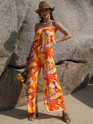 Floral print strapless jumpsuit in tangerine with wide legs and tie back detail.