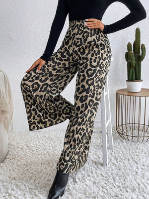 Leopard print palazzo trousers with a high waist and wide leg, styled with a black top and boots.