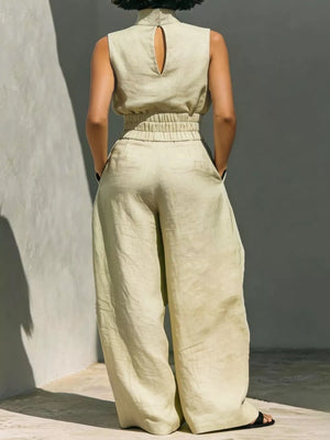 Apricot sleeveless turtleneck top with keyhole back and elastic waist, paired with wide-leg pants.