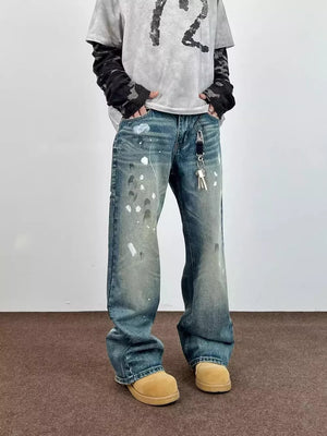 Blue 100% cotton wide leg jeans with paint splatters and distressed details.