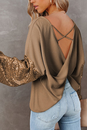 Tan waffle knit top with sequin sleeves and crisscross back detail.