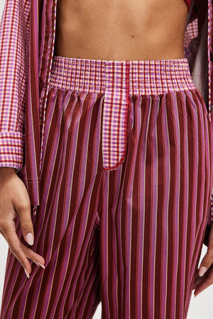 Crimson stripe palazzo trousers with a deep purple gingham waistband and red trim.
