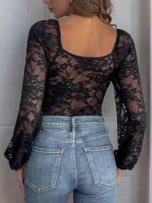 Black lace bodysuit with blouson sleeves and square neckline, paired with denim jeans.