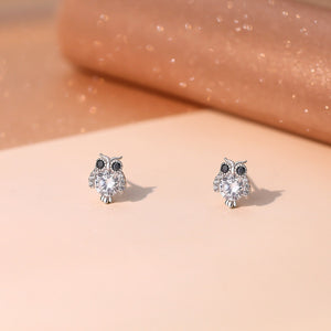 Sterling silver owl stud earrings with clear and black cubic zirconia accents.