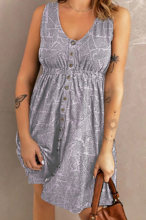 Sleeveless midi dress in light gray with a newspaper print, V-neck, button front, and elastic waist.