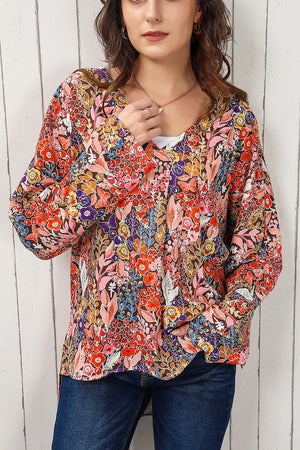 Painterly floral oversized blouse with V-neck and flared sleeves, in a colorful floral print.