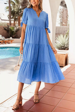 Blue tiered midi dress with notched neckline and tie sleeves