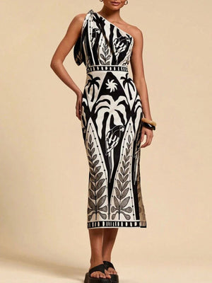 Tropical print one-shoulder midi dress in black and white with a defined waist and elegant cut.