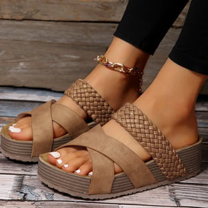 Braided strap platform slides in Camel with crisscross straps and a thick sole.