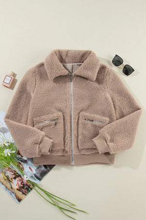 Mocha teddy bomber jacket with zip pockets and ribbed cuffs.
