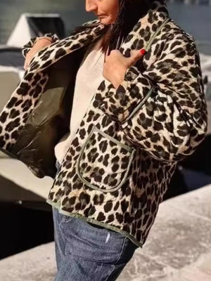 Leopard quilted kimono jacket with pockets and contrast trim, worn open over a cream sweater.
