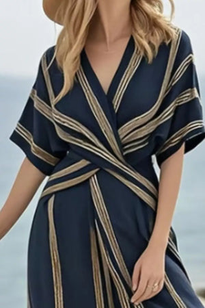 Dark navy wrap maxi dress with gold stripes, V-neck, short sleeves, and a flowing skirt.