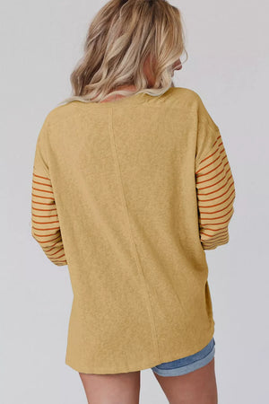 Mustard maternity shirt with bishop sleeves featuring horizontal stripes and a crew neck.