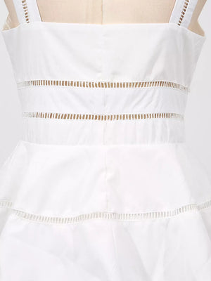 White midi dress with eyelet embroidery detail at the waist and hem.