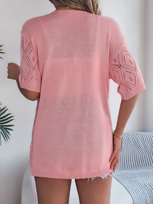 Blush pink open-knit cardigan with diamond pattern sleeves and a relaxed fit.