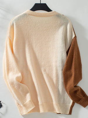 Colorblock cable knit raglan sweater in cream and caramel with ribbed crewneck and cuffs.