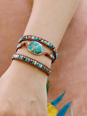 Aqua stone and leather wrap bracelet with beaded accents and oval center stone.