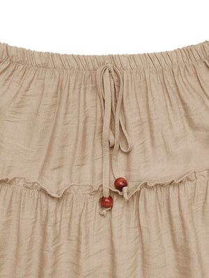 Tiered maxi skirt in tan with drawstring waist and wooden beads.