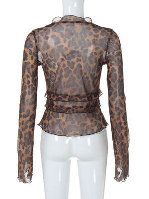 Chic animal print sheer blouse with ruffled neckline and tiered hem detail.