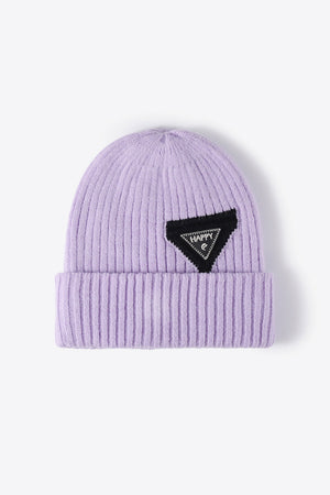 Purple ribbed acrylic beanie with a black triangle patch that says HAPPY