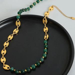 Green beaded necklace with gold oval chain links and gold accent beads